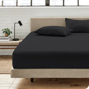 Bedroom scene with organic cotton fitted sheet and pillowcases on a bed