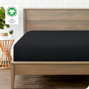 Modern wood bed frame with a sateen fitted sheet on the mattress