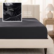 Sateen fitted sheet on a bed with a close-up of a sewn-in tag, set in a bedroom.