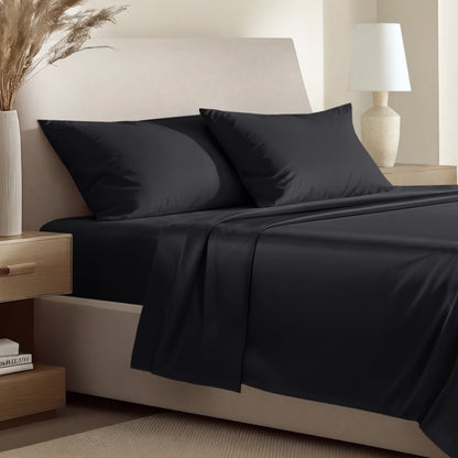 Sateen bedding set including a fitted sheet and two matching pillowcases on a bed.