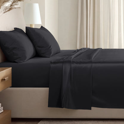 Sateen sheet set on a bed in a softly lit bedroom.