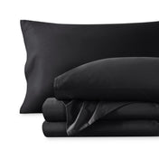 A sateen sheet set folded and stacked on a white background.
