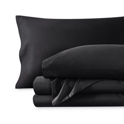 A sateen sheet set folded and stacked on a white background.