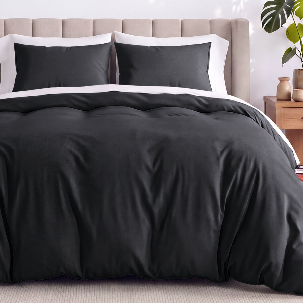Neatly made bed with organic jersey bedding and pillow shams in a bedroom setting.