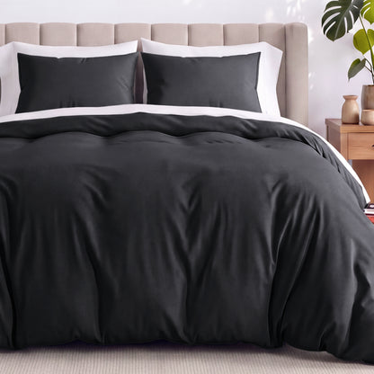 Neatly made bed with organic jersey bedding and pillow shams in a bedroom setting.