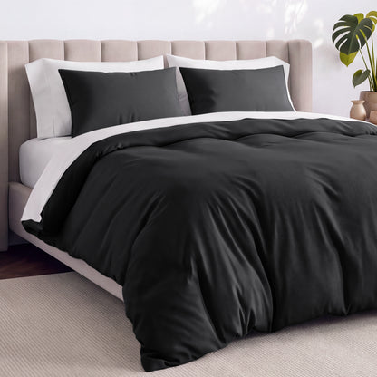 Bed with jersey duvet set against a beige headboard.