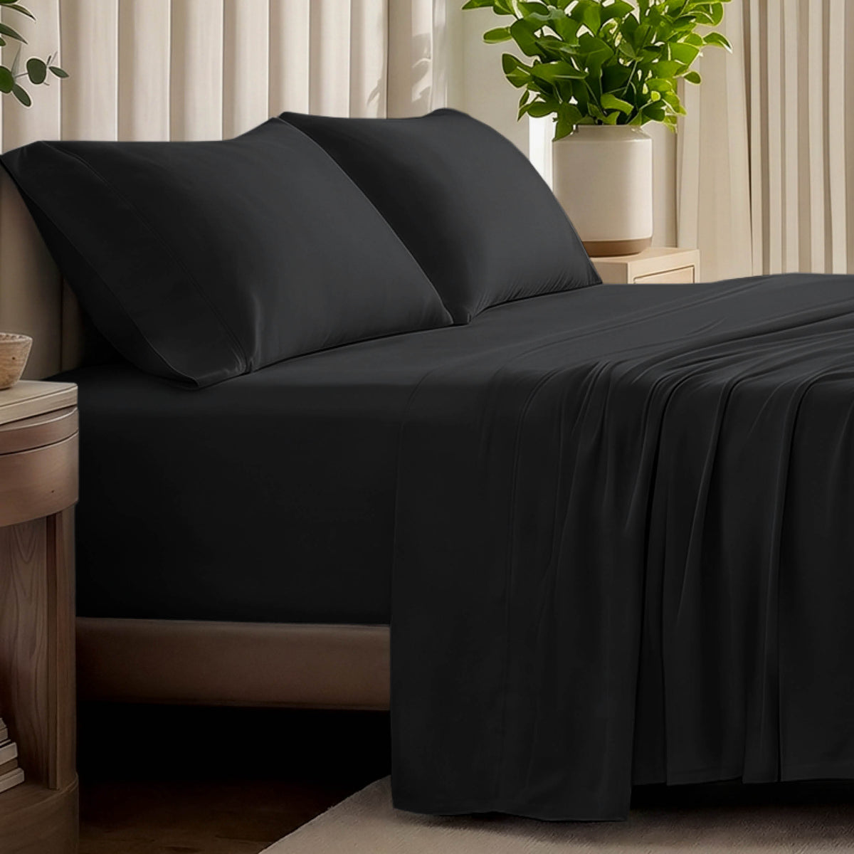 Organic jersey bed sheets and pillows on a bed with a wicker headboard.