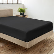 Diagonal view of room scene with percale fitted sheet on the bed