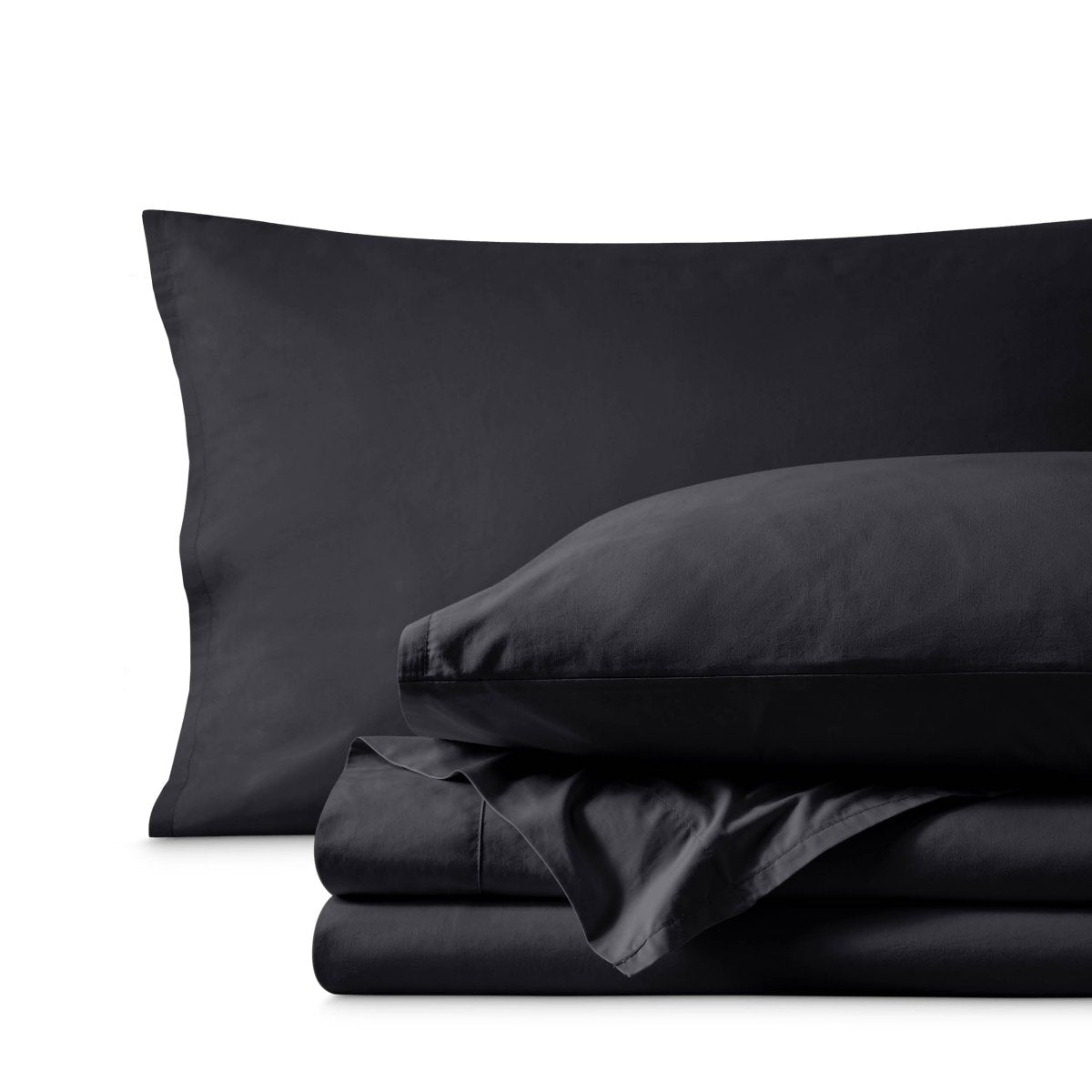 Percale bedding set including pillowcases and folded sheets arranged on a clean white background