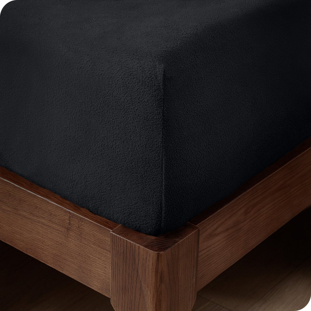 Close up of the corner of a mattress with a fleece fitted sheet on it