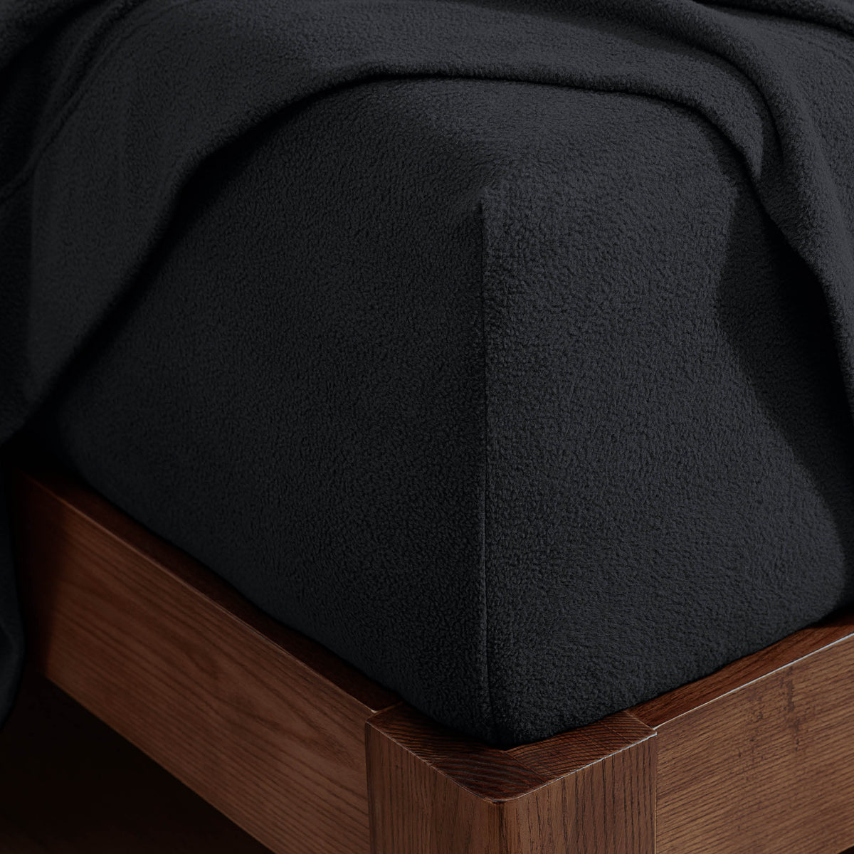 Corner of a mattress with a fitted sheet on it