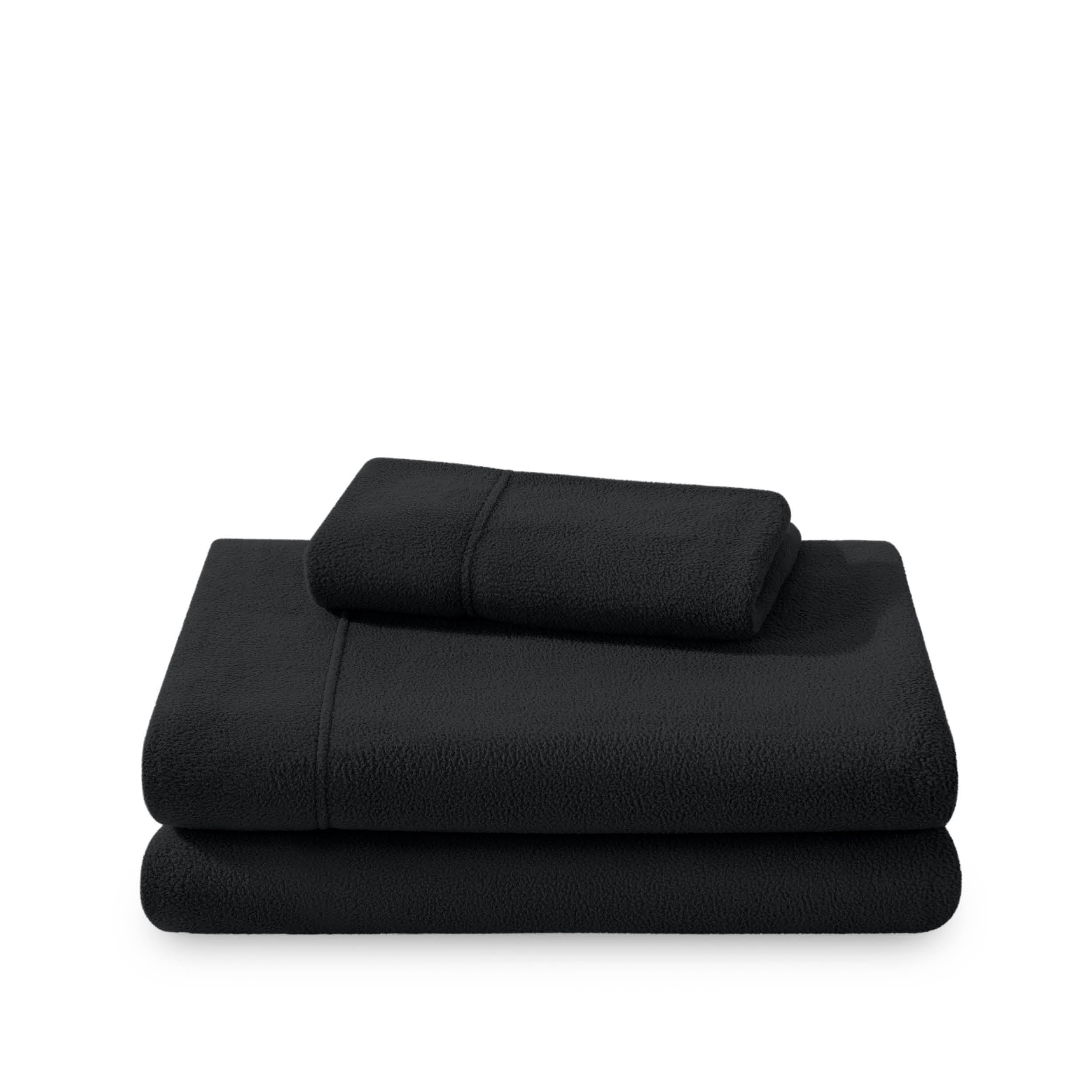 Polar fleece sheets and pillowcases folded and stacked on a white background