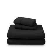 Polar fleece sheets and pillowcases folded and stacked on a white background