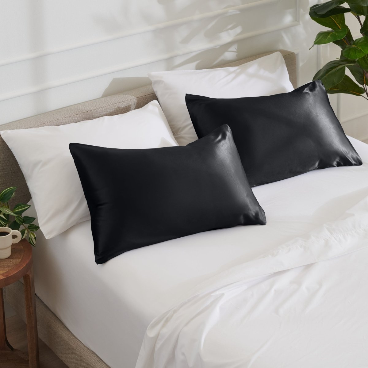 Satin pillowcases on a bed with white bedding