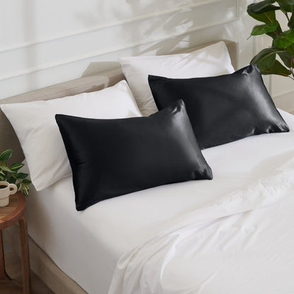 Satin pillowcases on a bed with white bedding