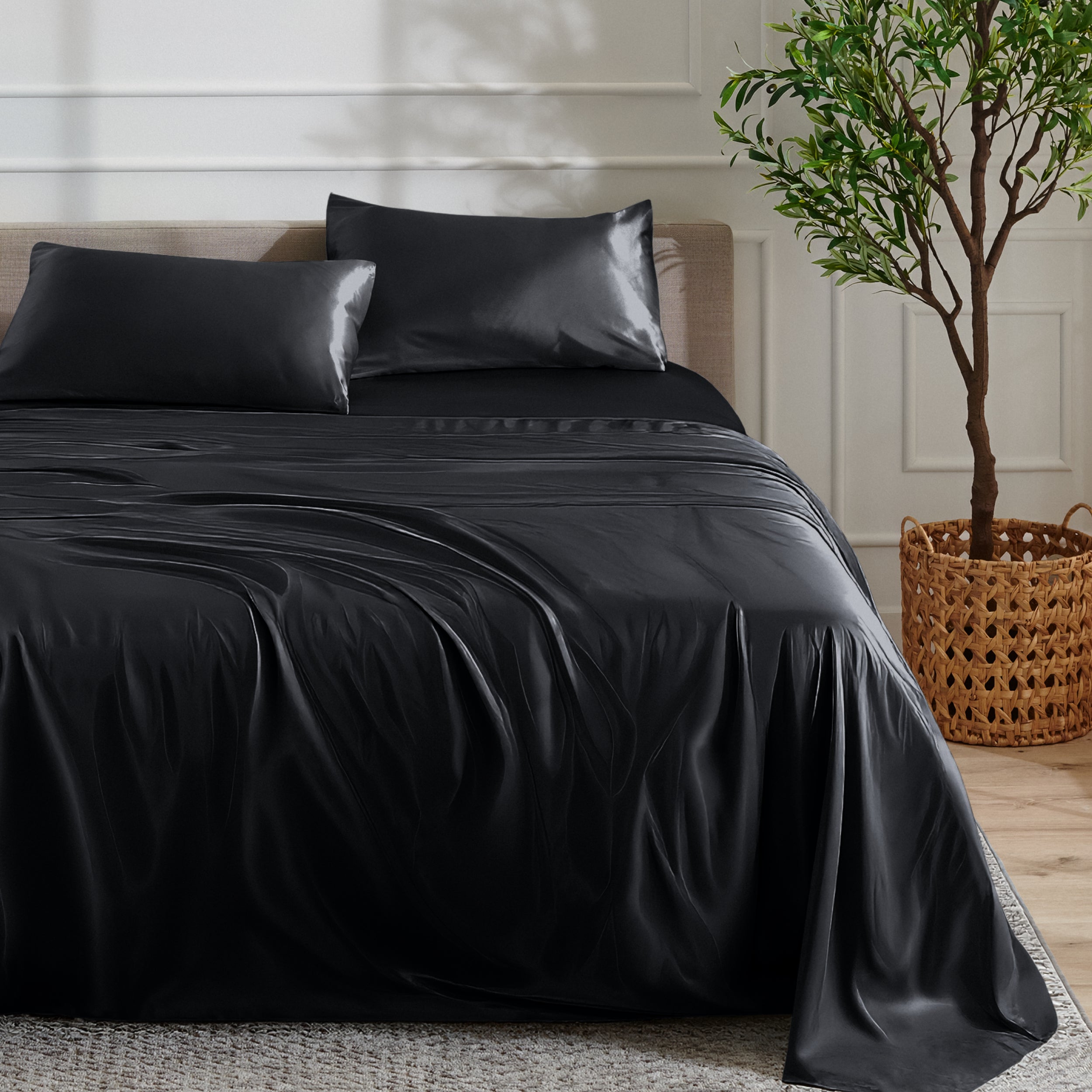 Satin sheet set on a bed with a plant and basket in the background