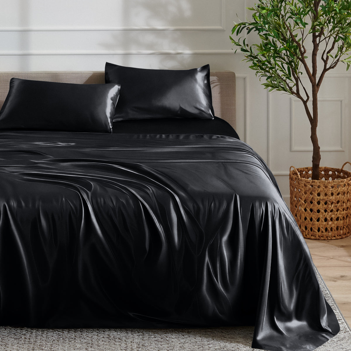 Satin sheet set on a bed with a plant and basket in the background