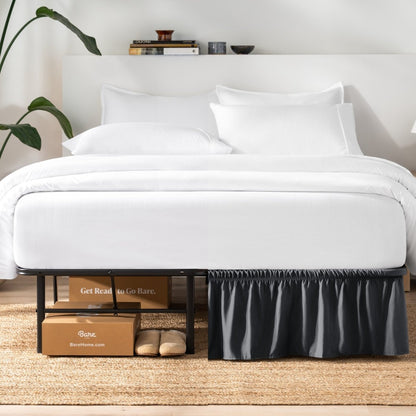 Bed with white bedding and a plant near the bed.