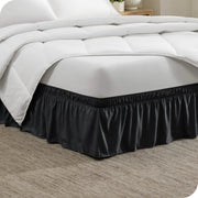Corner of a bed with a polyester wrap around bed skirt on it