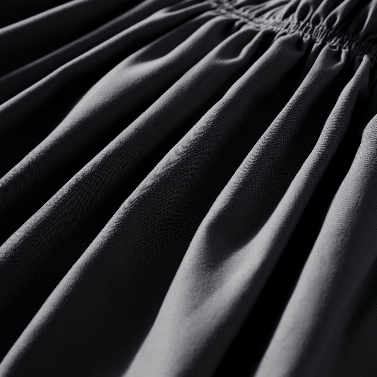 Close-up of polyester bed skirt fabric with a focus on texture and folds.