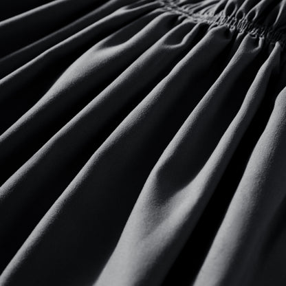 Close-up of polyester bed skirt fabric with a focus on texture and folds.