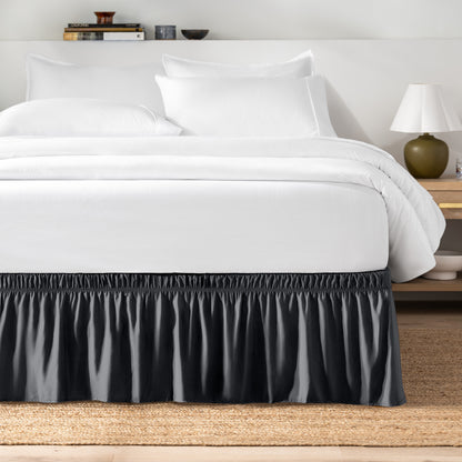 Bed with white bedding and a bed skirt.