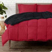 A wooden bed frame with a reversible comforter and sheet set on the mattress