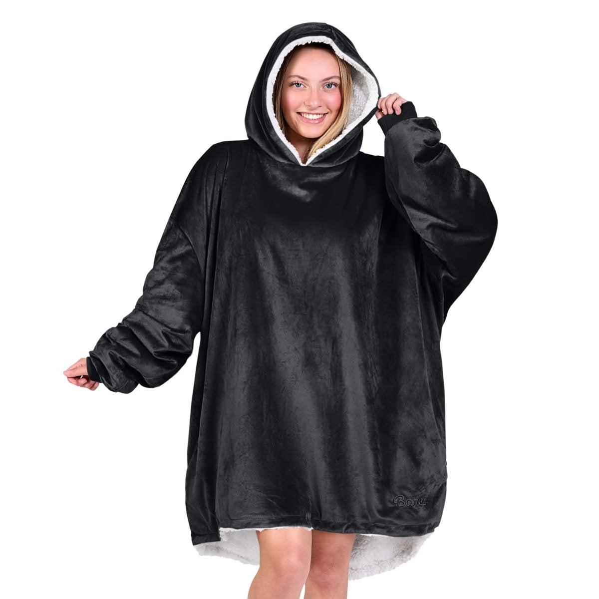 An adult with a hooded wearable blanket on