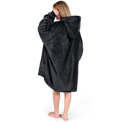 An adult with a sherpa wearable blanket on