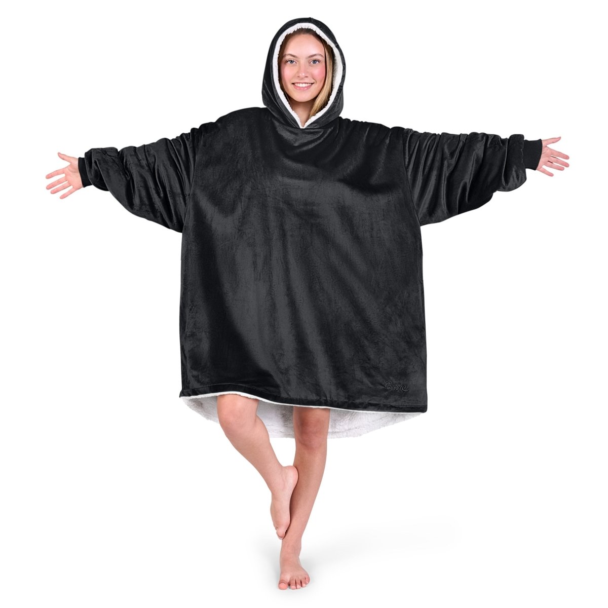 An adult with a hooded wearable blanket on