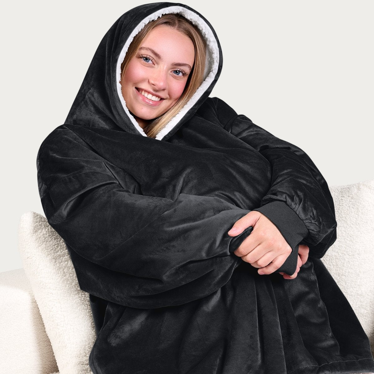An adult with a sherpa wearable blanket on