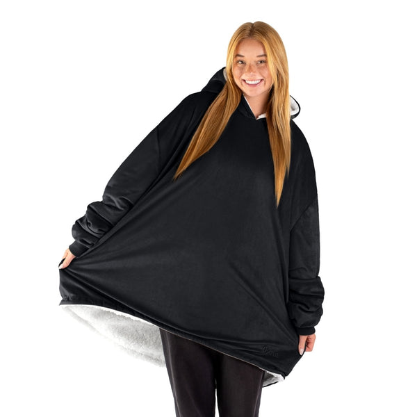 An adult with a sherpa wearable blanket on