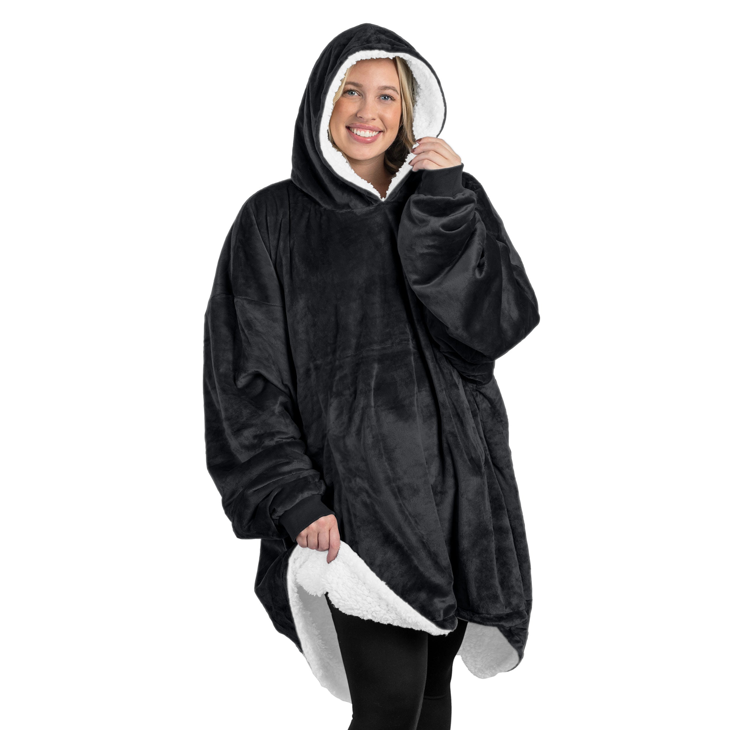 A oversized sherpa wearable blanket with a hood on a woman.