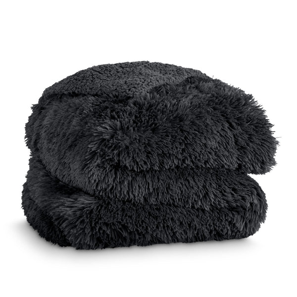A shaggy faux fur blanket folded