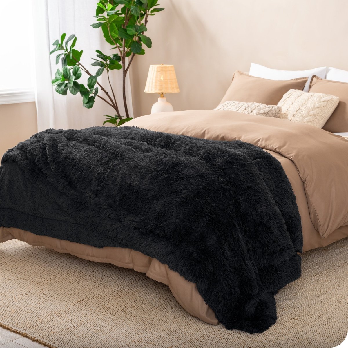 A shaggy faux fur blanket on the end of a bed