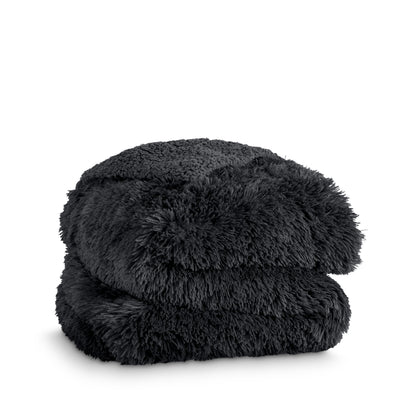 A shaggy faux fur blanket folded