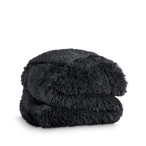 A shaggy faux fur blanket folded
