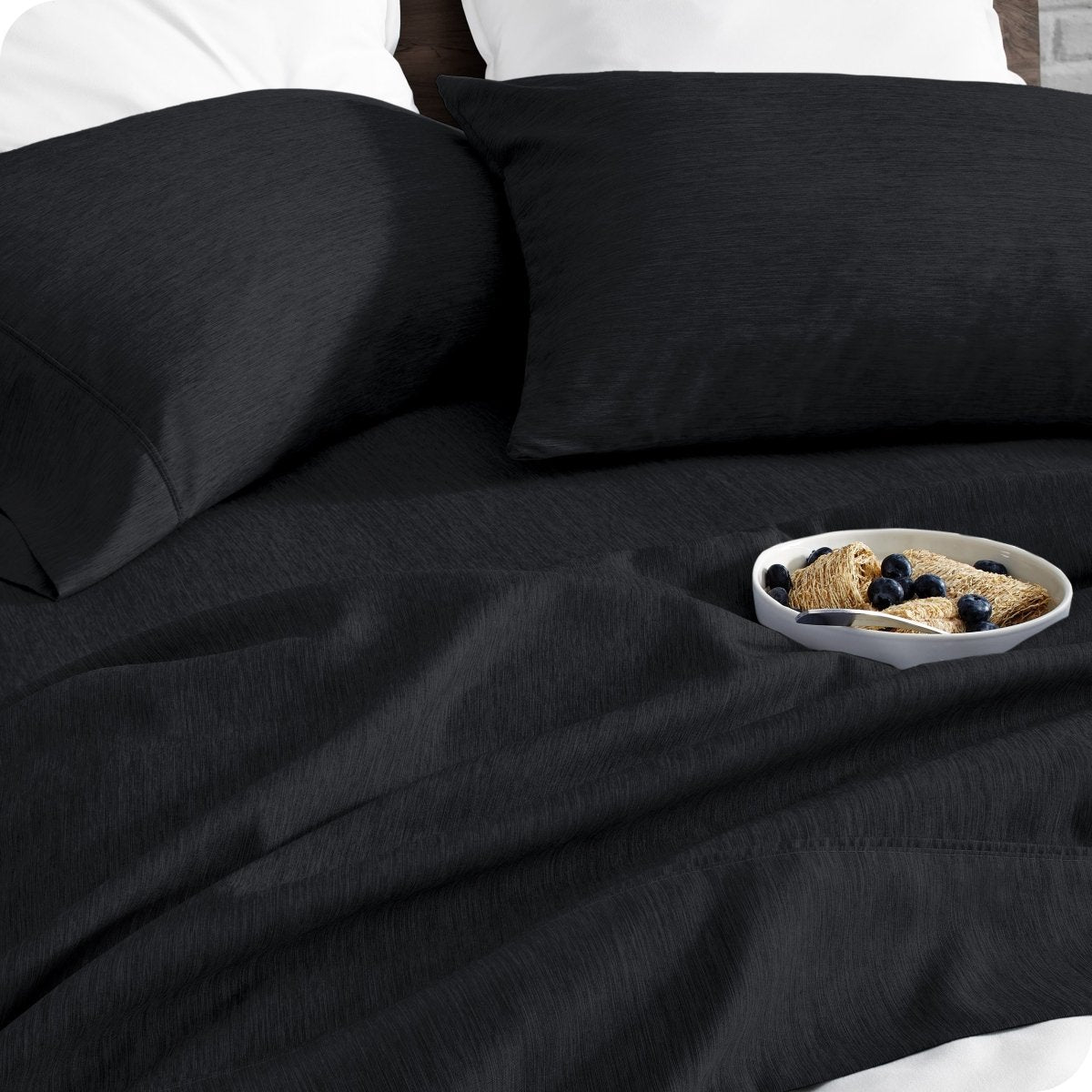Bedding set on a bed with a bowl of cereal on a white background