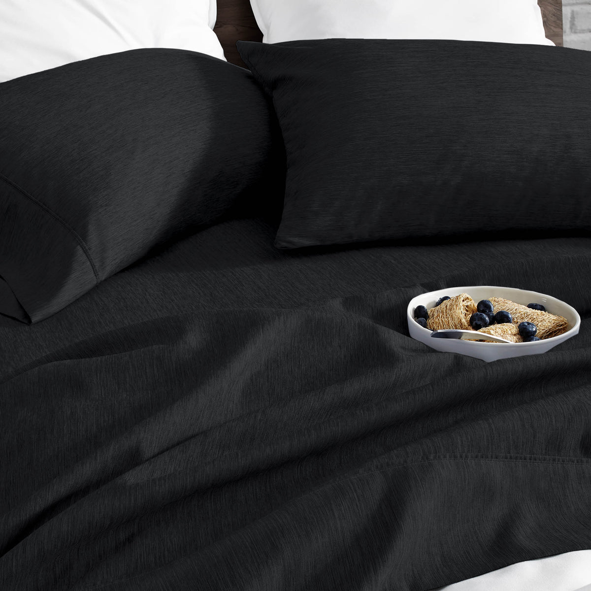 Ultra soft sheet set with a bowl of food on a bed
