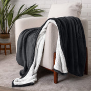 Blanket draped over a chair in a cozy living room setting.