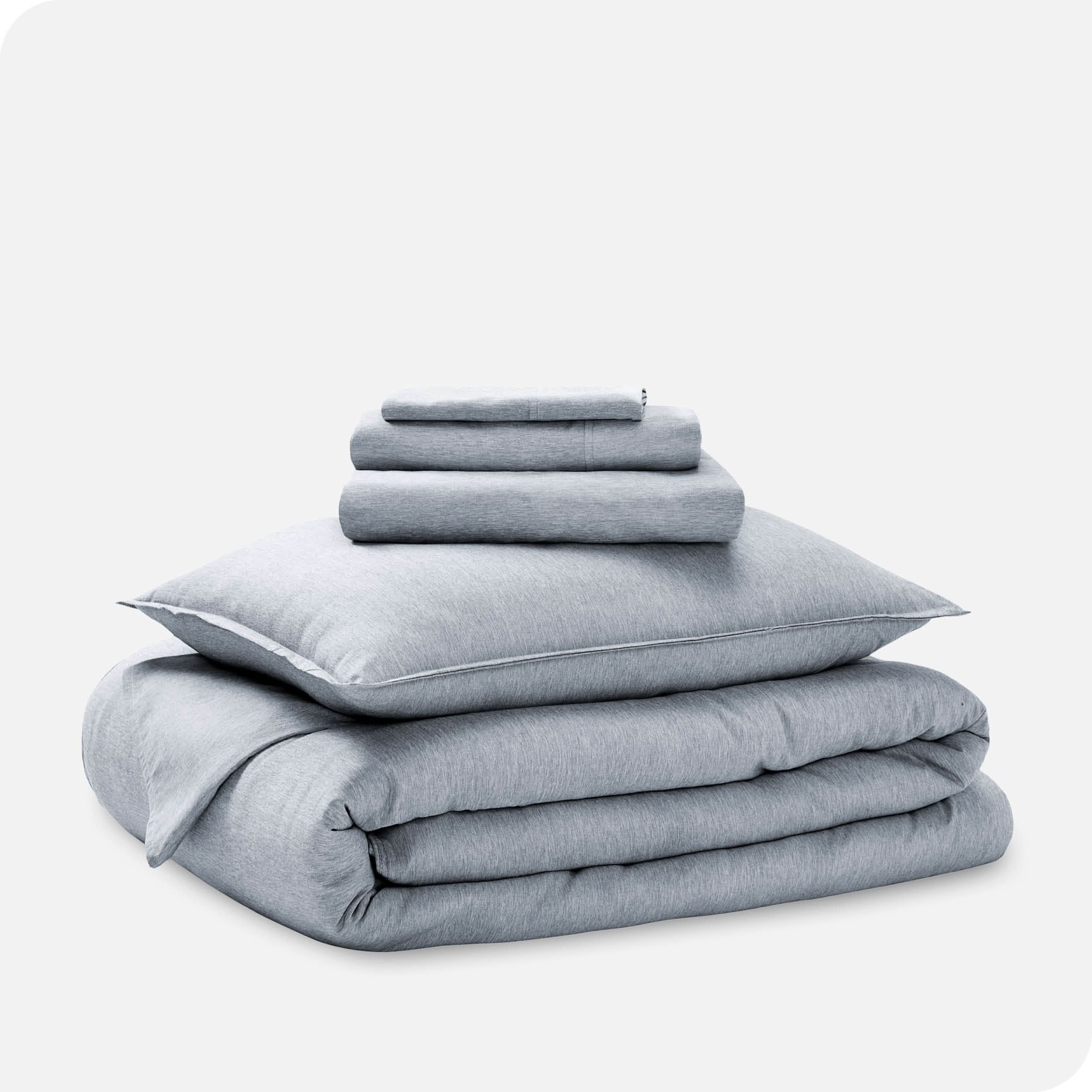 A heathered bedding set folded and stacked.