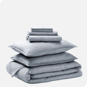 A heathered bedding set folded and stacked.