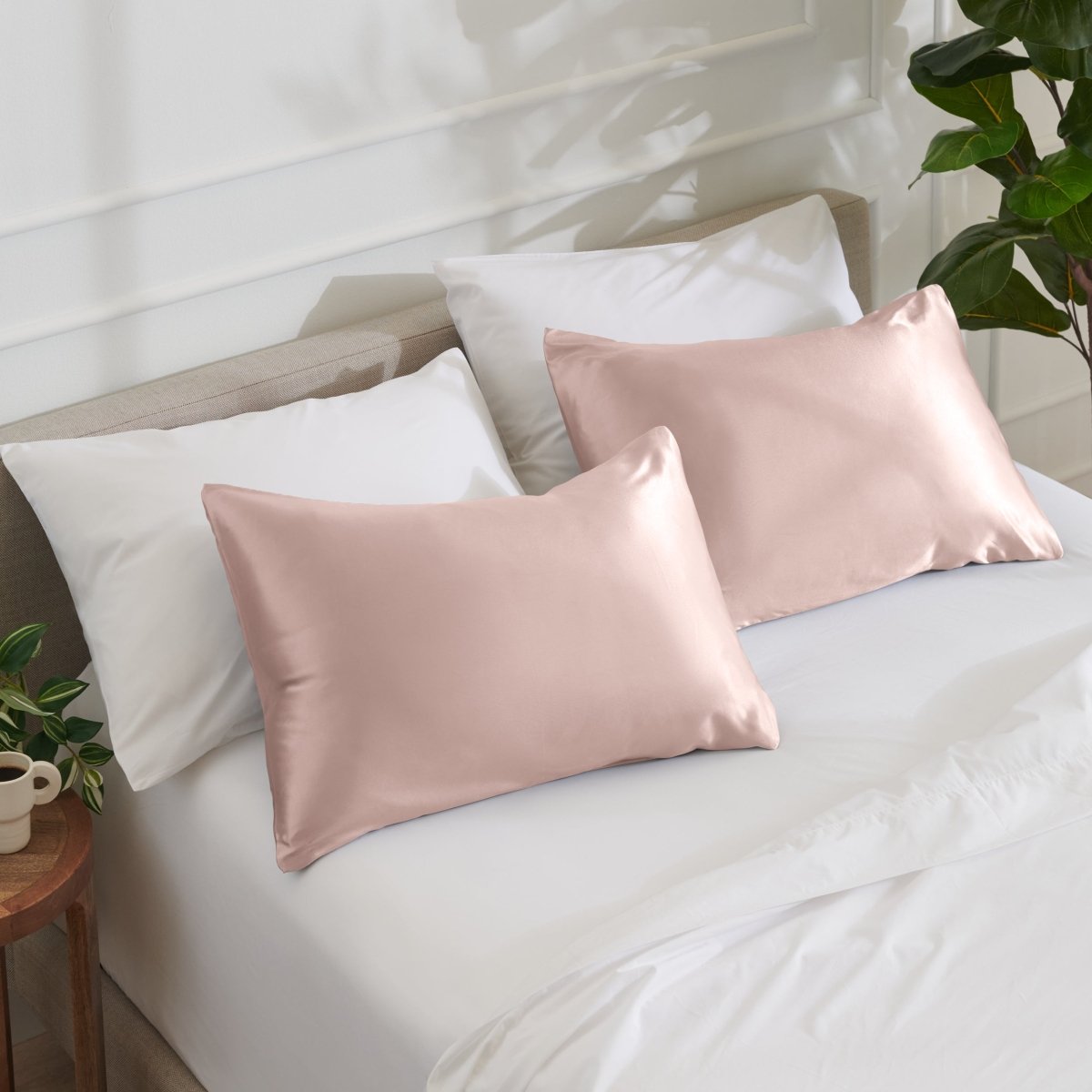 Satin pillowcases on a bed with white bedding