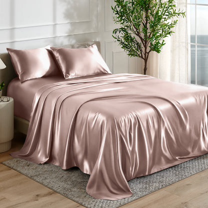 Satin sheet set on a bed in a bedroom with a plant and window in the background.
