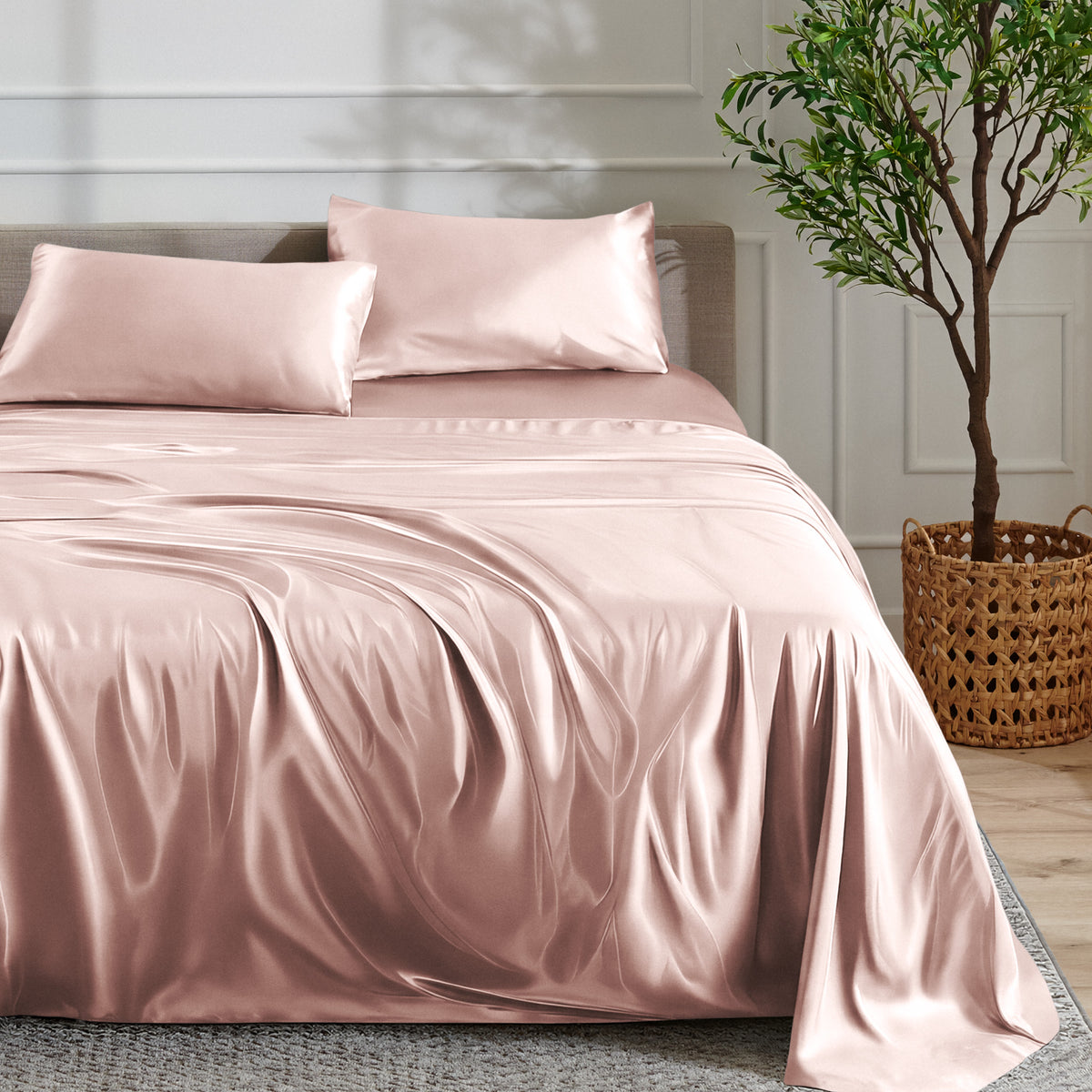 Satin sheet set on a bed with a plant and basket in the background
