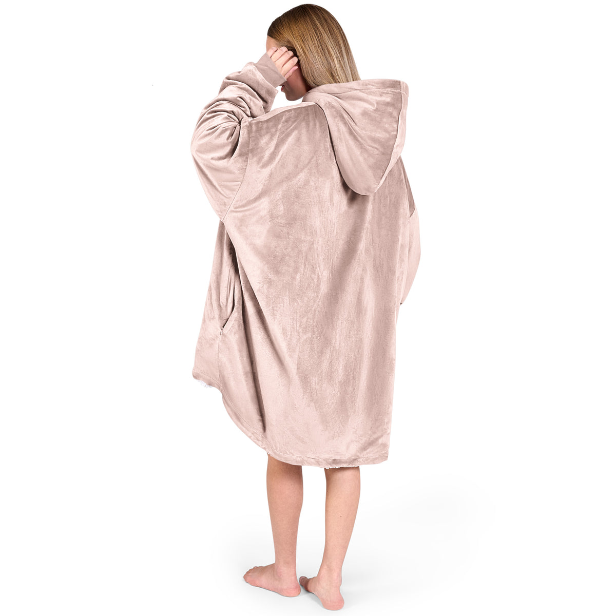 An adult with a hooded wearable blanket on