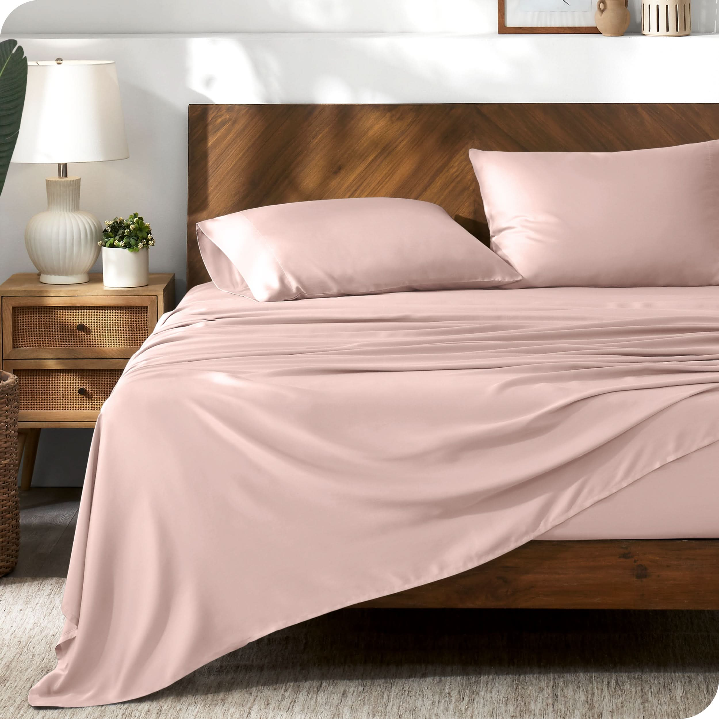 TENCEL™ sheet set on a bed. The flat sheet is draped over the side and end of the bed.