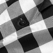 Close-up of a black and white checkered fabric with a button.