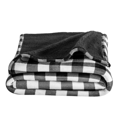Folded black and white checkered blanket on a white background