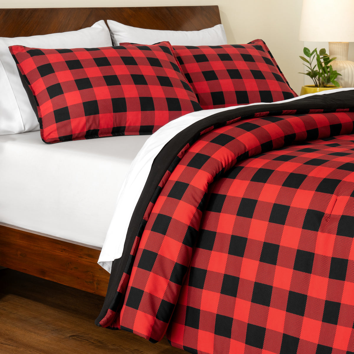 Track stitch comforter on a bed with white pillows and a wooden headboard.